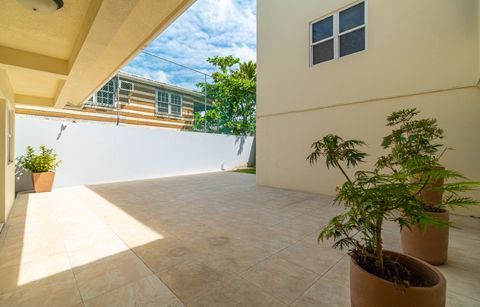 Shaded tiled courtyard at the side of the hotel with potted plants