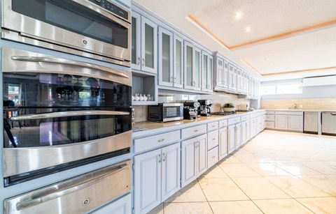 Kitchen with a stainless steel double oven and glass-front cabinets