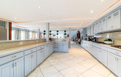 Kitchen counter and cabinets looking towards the windows