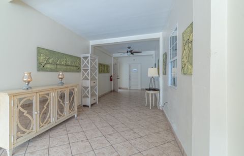 A bright interior corridor with console tables and mirrors
